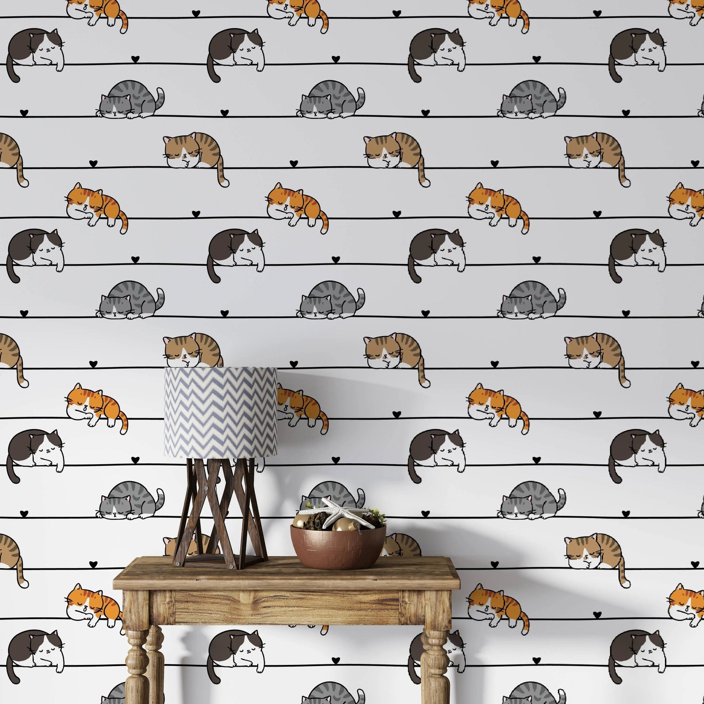 Cartoon cats wallpaper behind a wooden console table with a lamp and decor