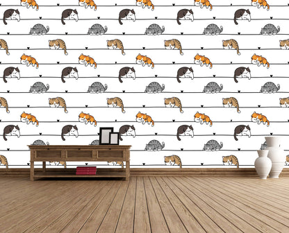 Cartoon cats wallpaper accent wall behind a wooden console table with framed photos and white vases