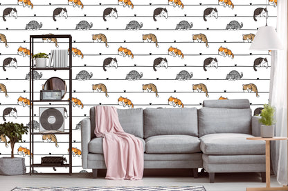 Cartoon cats wallpaper behind a gray sectional sofa and open shelving unit