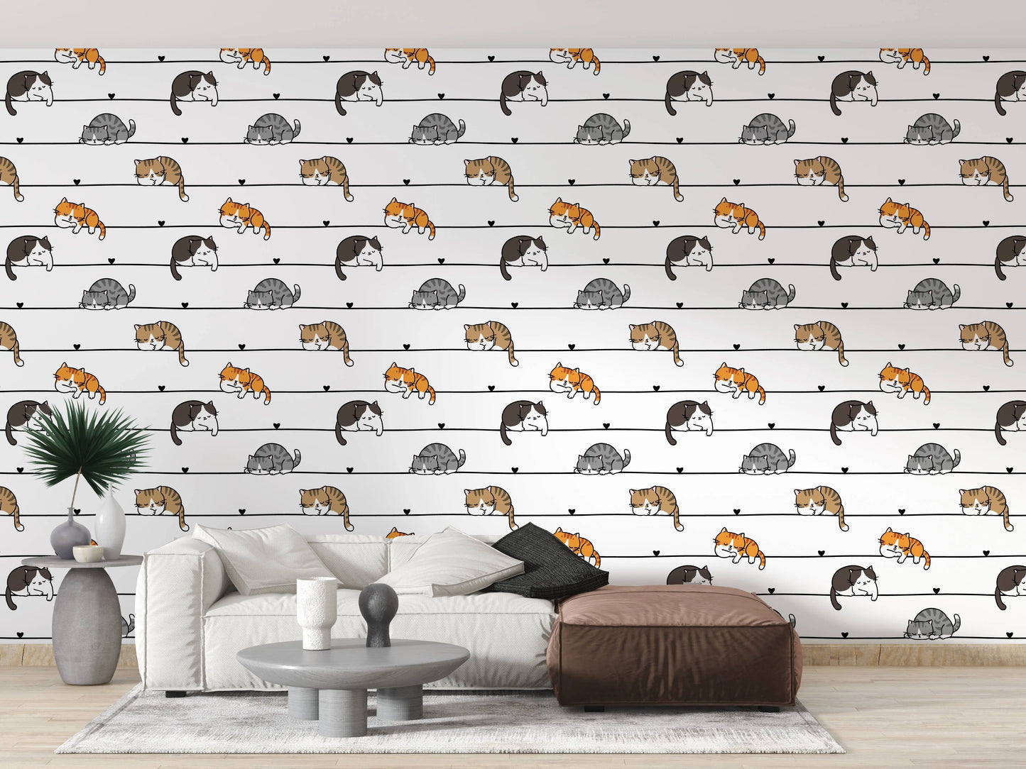 Cartoon cats wallpaper as a living room accent wall behind a white sofa and ottoman
