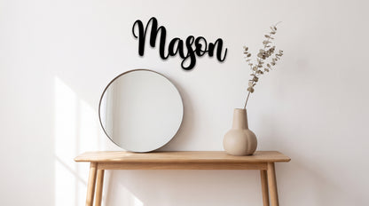 Custom cursive wood name sign "Mason" in black, displayed above a mirror and vase