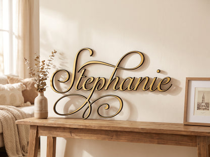 Custom cursive wood name sign "Stephanie" in gold, displayed on a console table