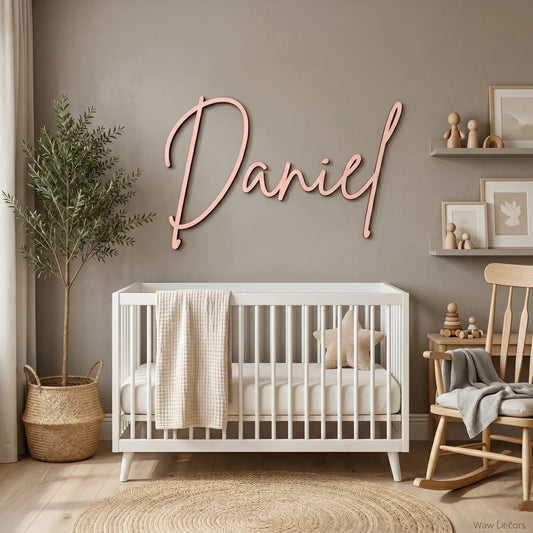 Custom wood name sign in cursive script mounted above a white crib in a nursery