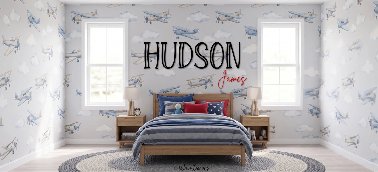 Custom "Hudson James" wood name sign in a kids room with an airplane wallpaper mural