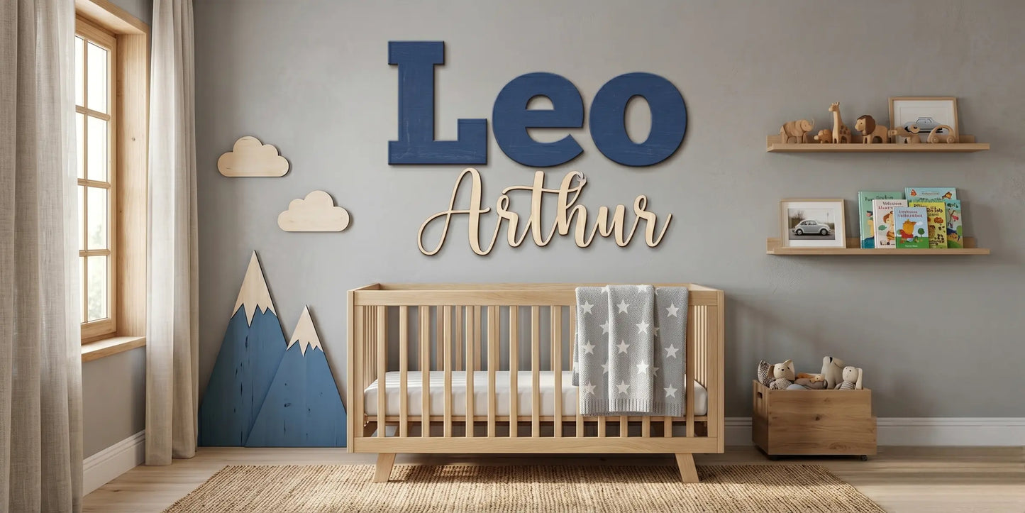 Custom "Leo Arthur" wood name sign in navy script against a mountain-themed nursery wallpaper