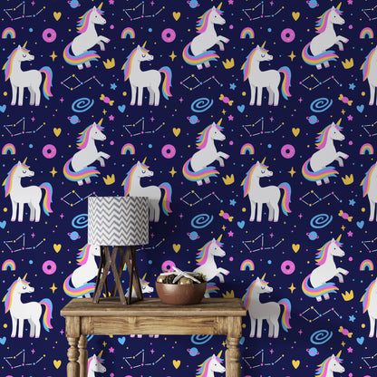 Galaxy unicorns wallpaper behind a wooden console table with a patterned lamp and decor bowl