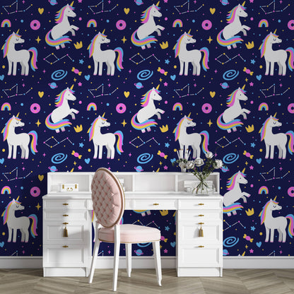 Galaxy unicorns wallpaper behind a white vanity desk with a pink chair and fresh roses