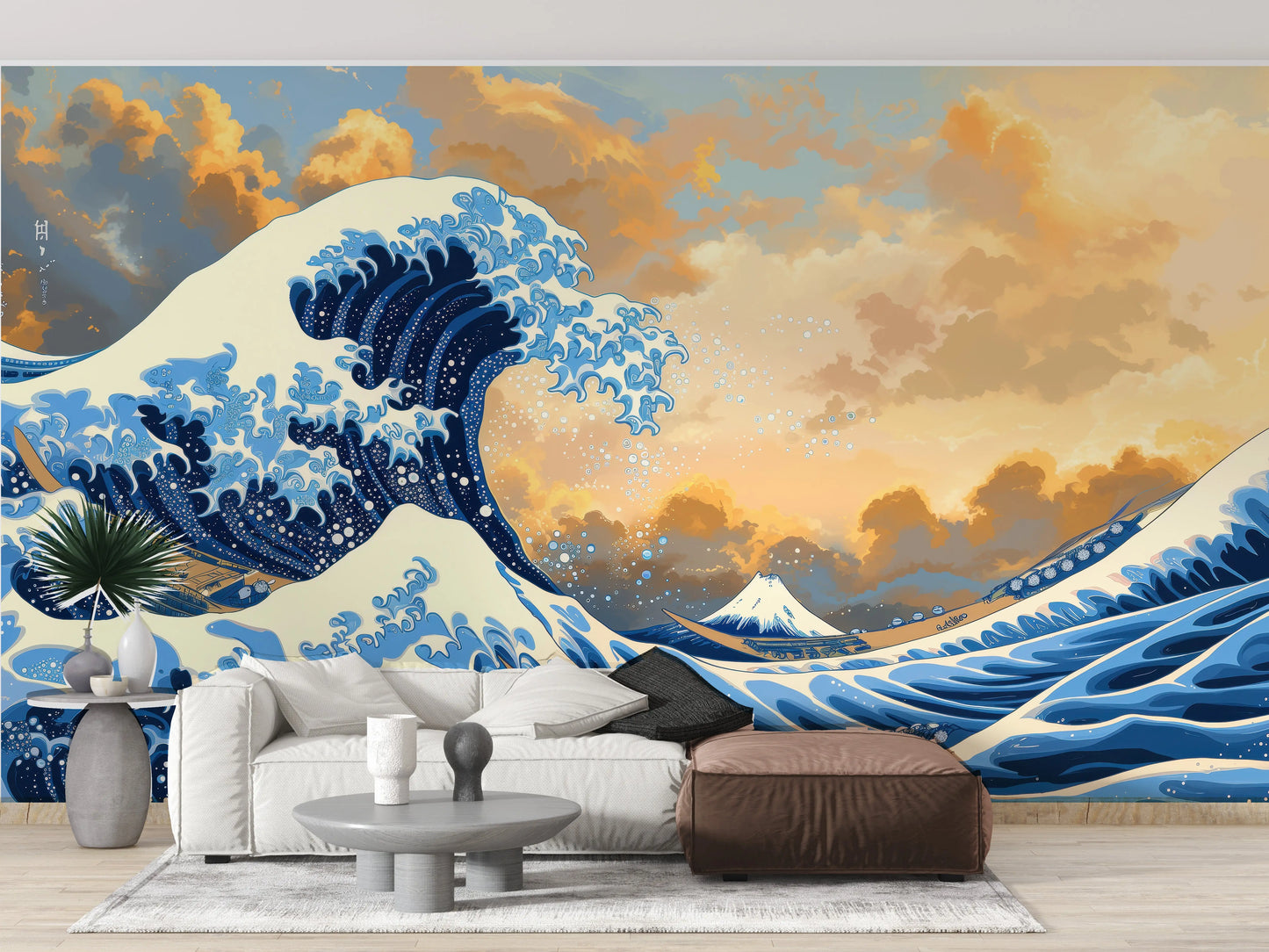 Great Wave off Kanagawa wall mural behind a cream sofa with a brown ottoman and round coffee table
