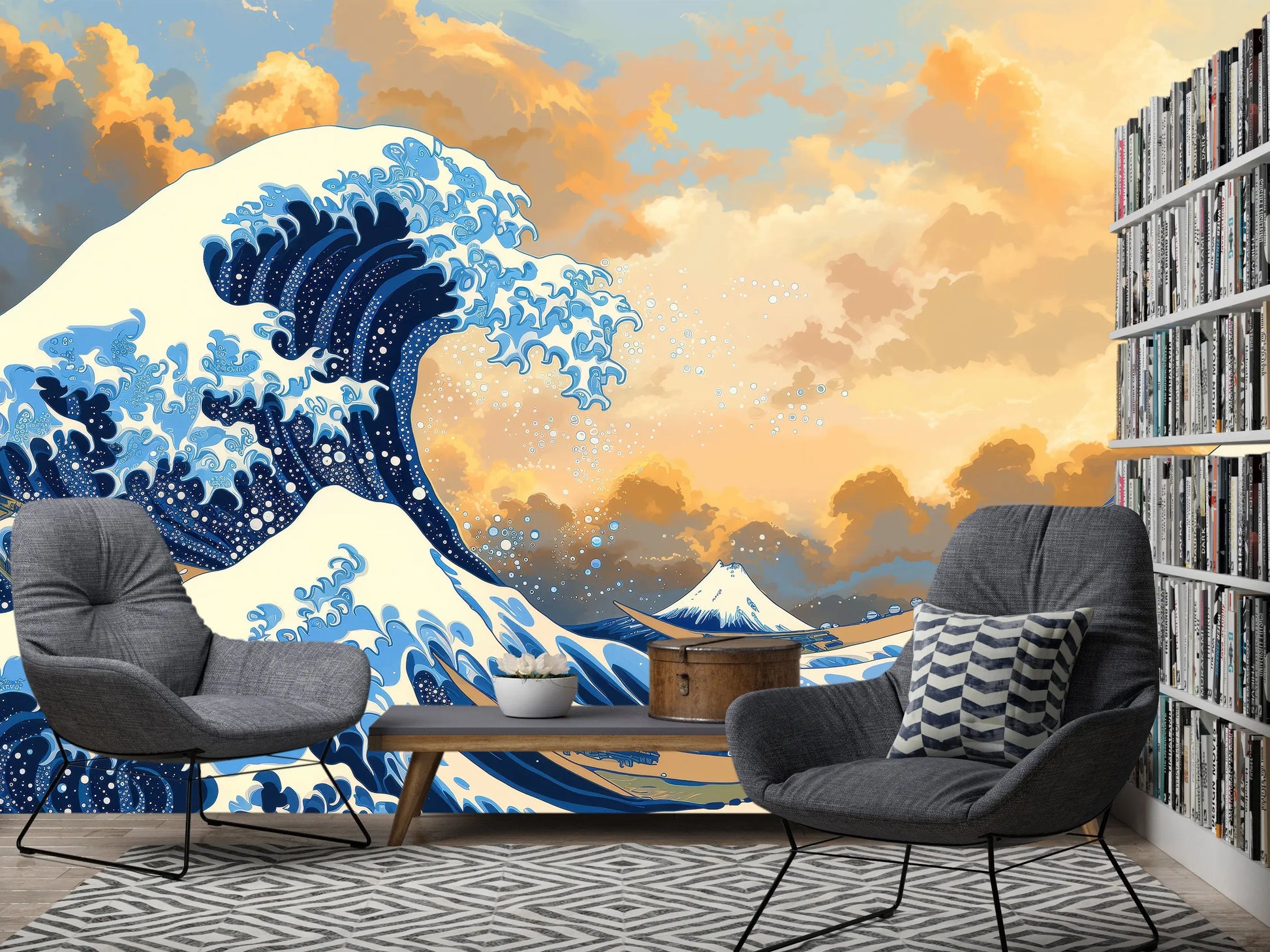 Great Wave off Kanagawa wall mural behind two gray armchairs and a bookshelf in a living room reading nook