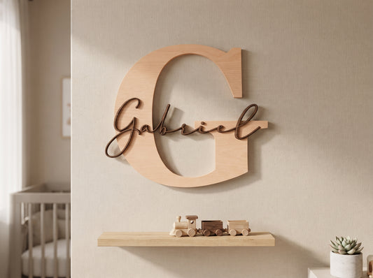 Monogram name sign with initial and script name above a nursery crib