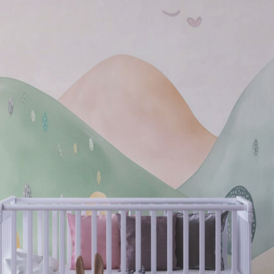 Pastel hills mural in a toddler playroom with bookshelf and toys