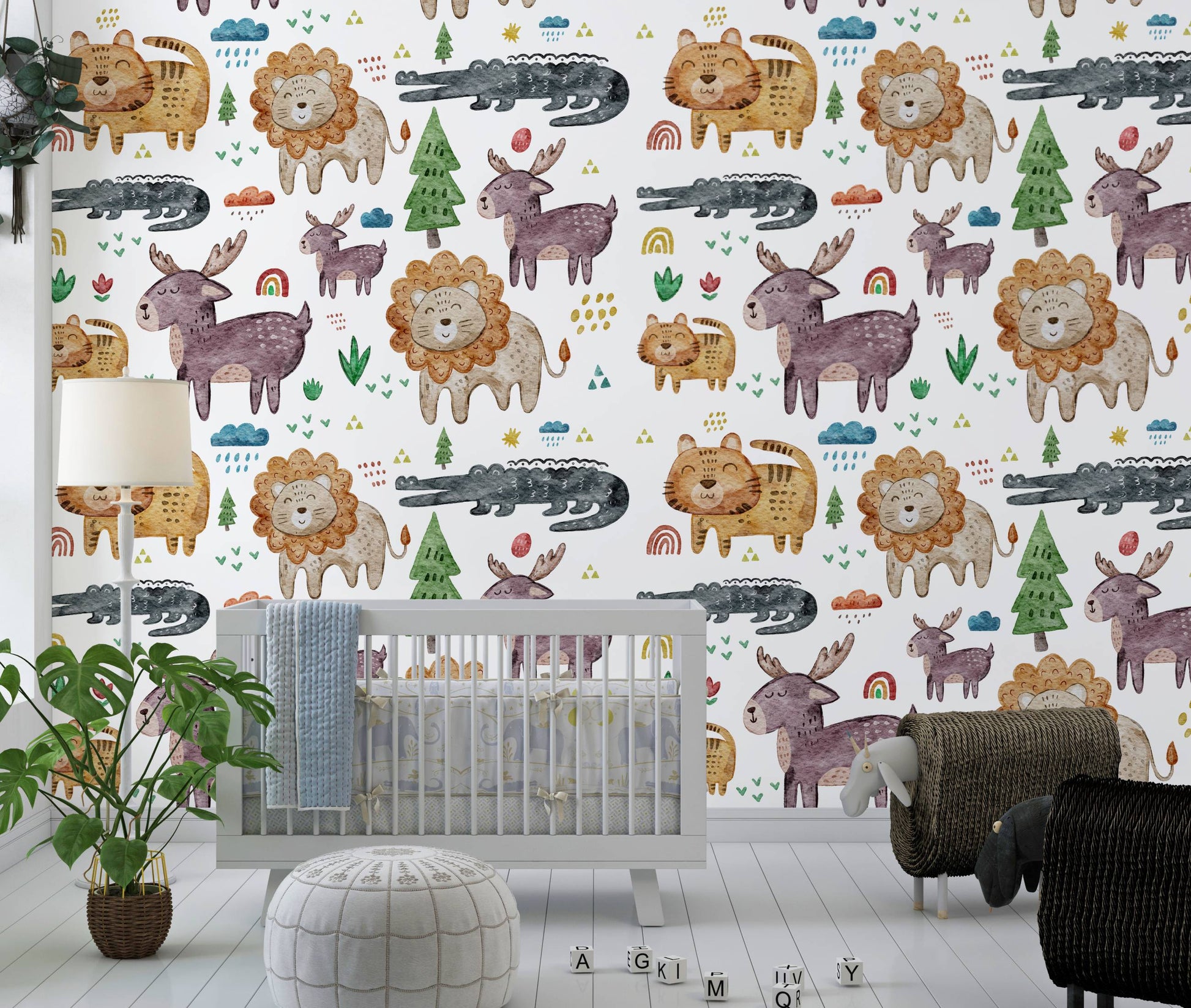 Safari animals nursery wallpaper behind a gray crib with a floor lamp and monstera plant