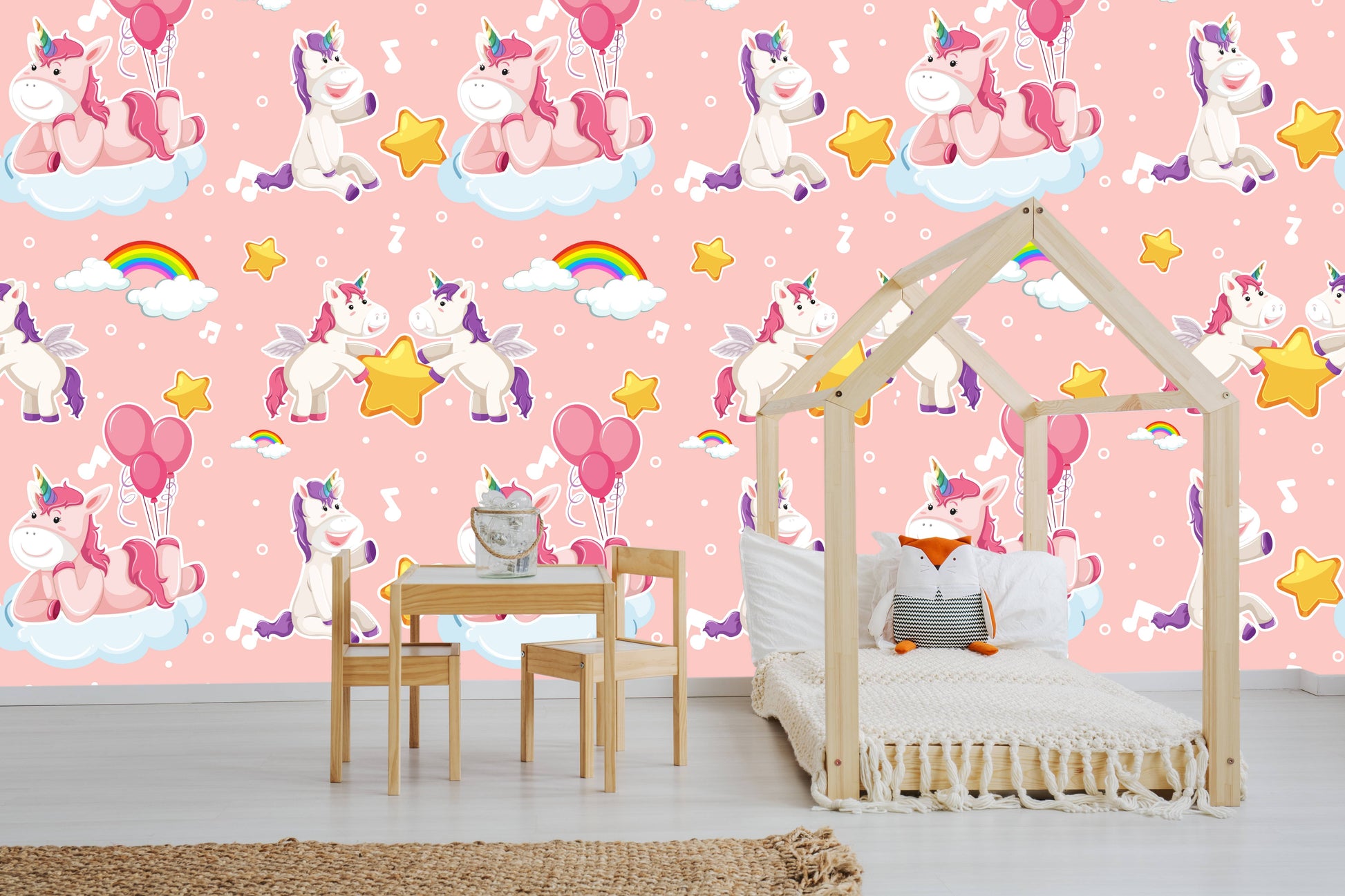 Unicorn clouds wallpaper behind a wooden house-frame bed with a fox pillow in a playroom