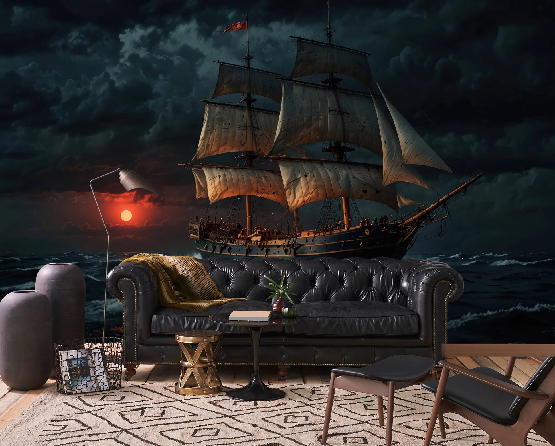 Vintage sailing ship wall mural with a dramatic sunset seascape, behind a dark leather sofa in a moody living room