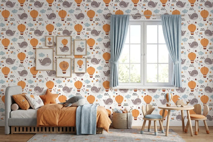 Hello World whale wallpaper behind a daybed and a kids' play table with blue curtains