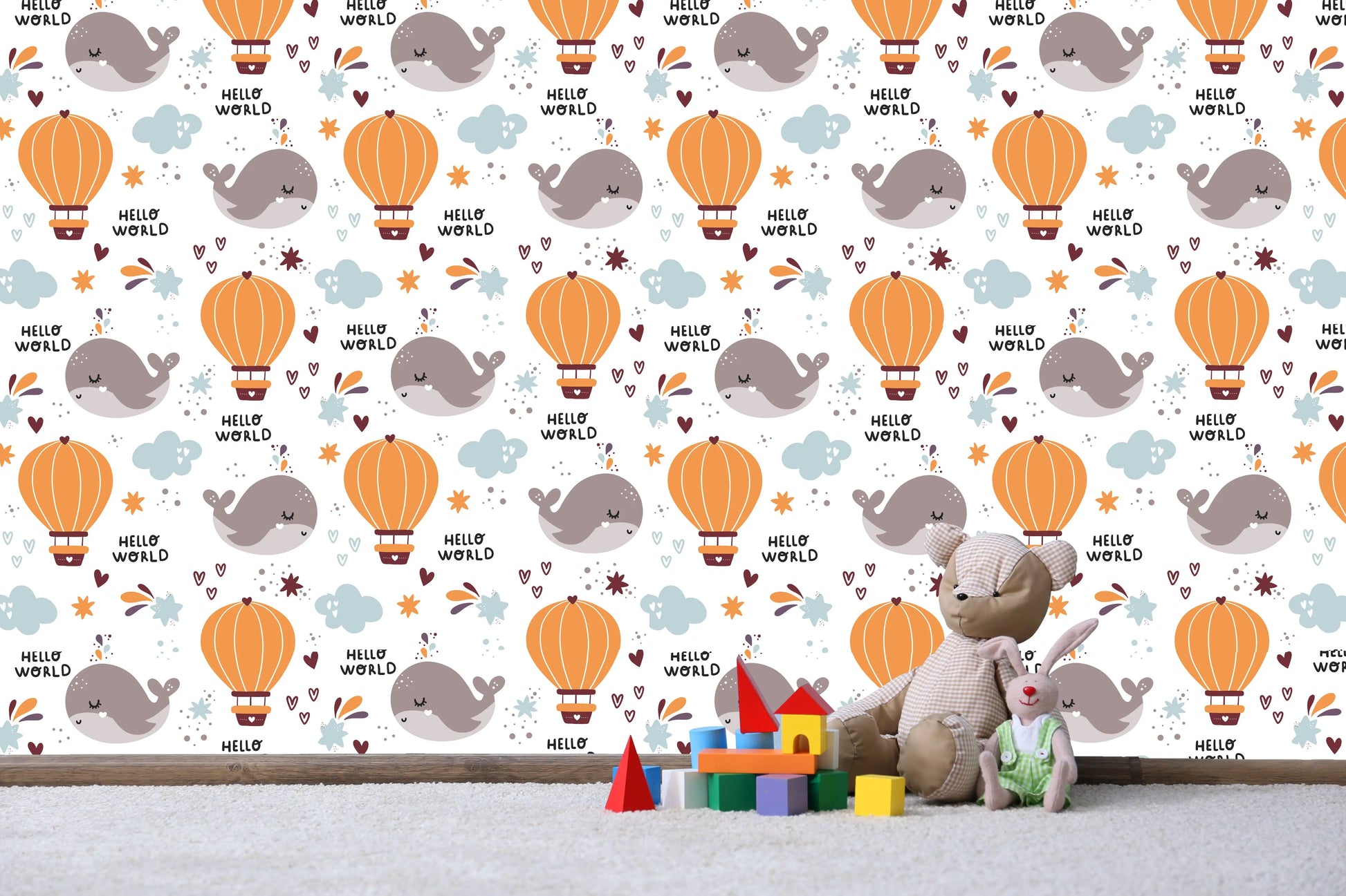 Close-up of the Hello World whale and hot air balloon wallpaper pattern with plush toys