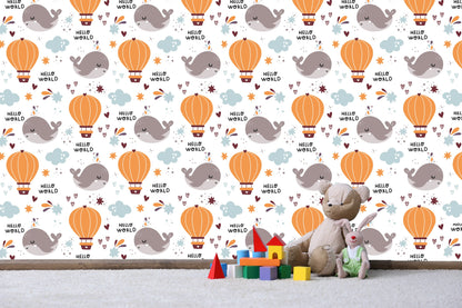 Close-up of the Hello World whale and hot air balloon wallpaper pattern with plush toys
