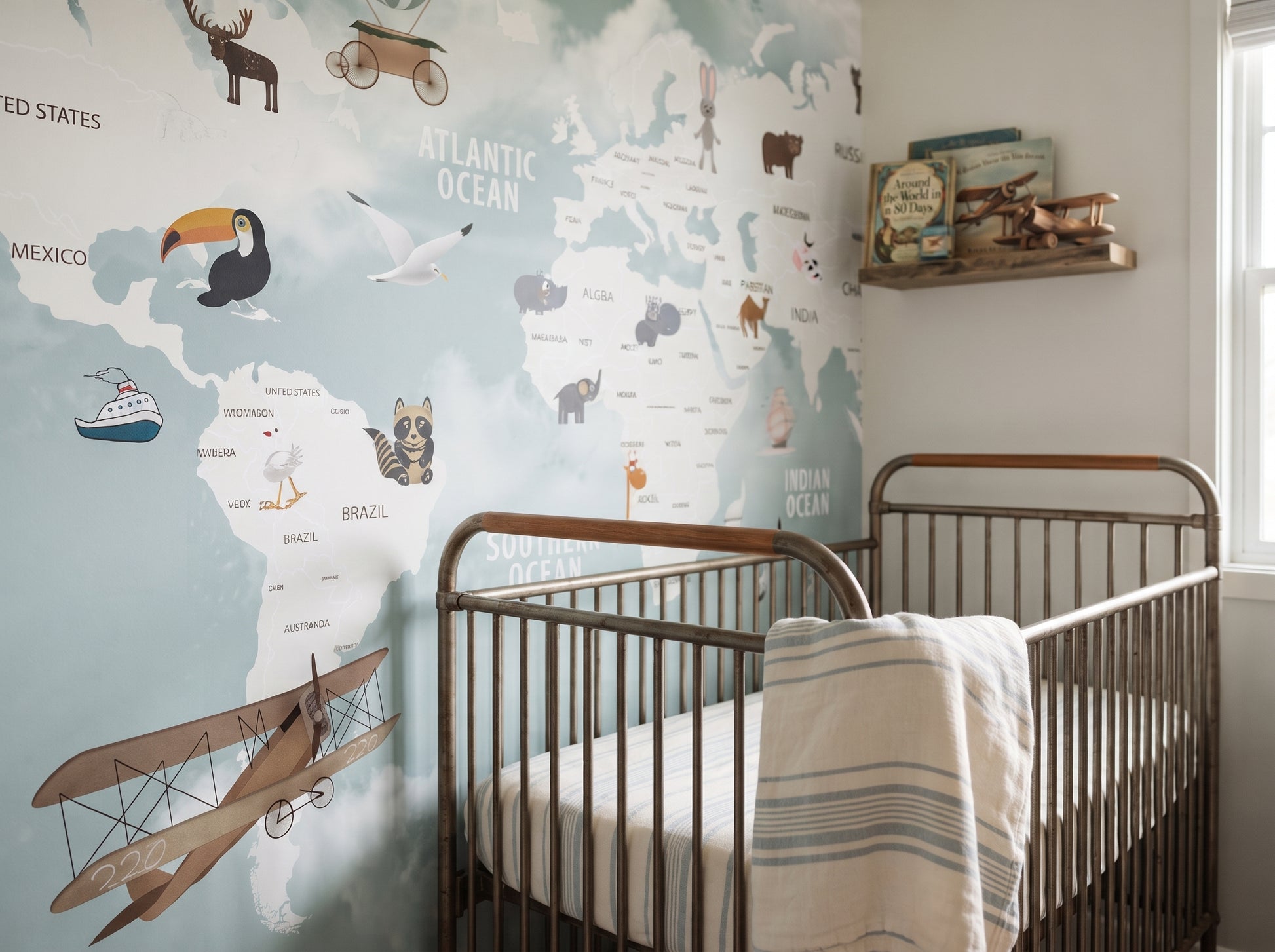 World explorer map wallpaper behind a metal crib with a book shelf and toy airplanes